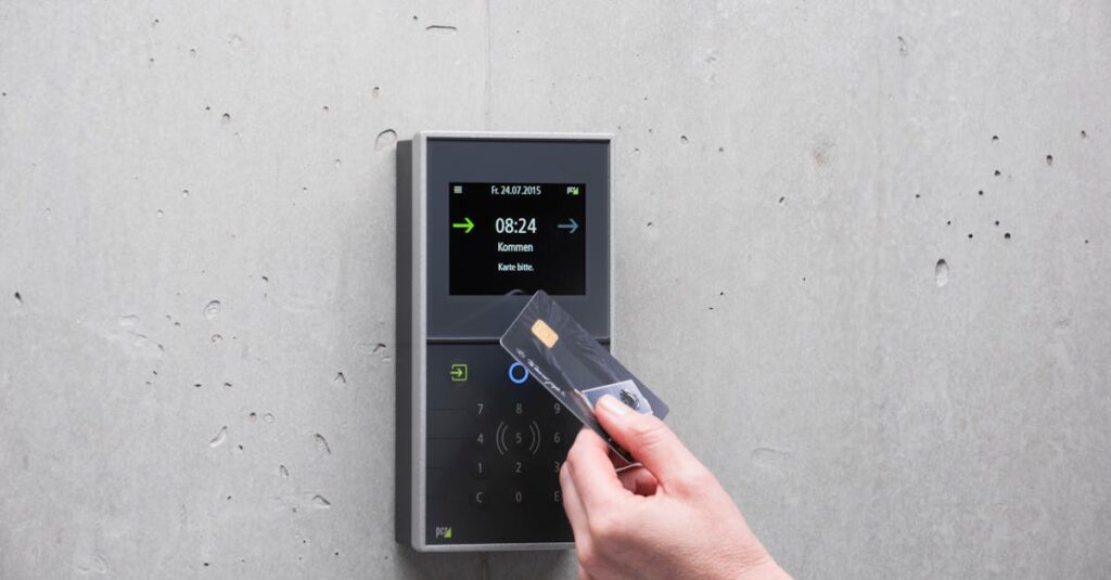 A businessman uses a secure card reader access system against a concrete wall.